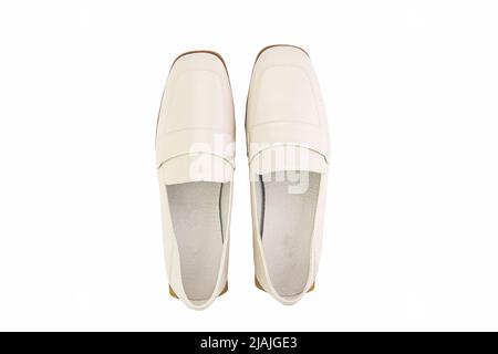 Stylish and elegant ivory women's loafers. Isolated close-up on white background. Top view. Fashion shoes Stock Photo