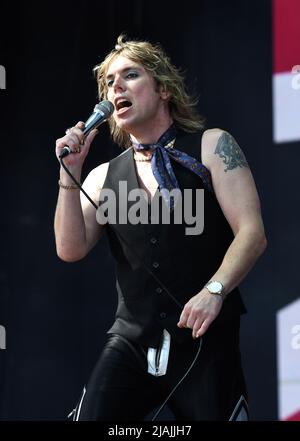 Lead singer Luke Spiller is shown performing on stage during a live concert appearance The Struts during the Boston Calling music festival held in Allston, Massachusetts on May 27, 2022. Stock Photo