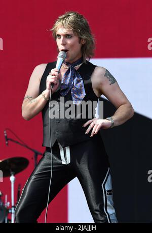 Lead singer Luke Spiller is shown performing on stage during a live concert appearance The Struts during the Boston Calling music festival held in Allston, Massachusetts on May 27, 2022. Stock Photo