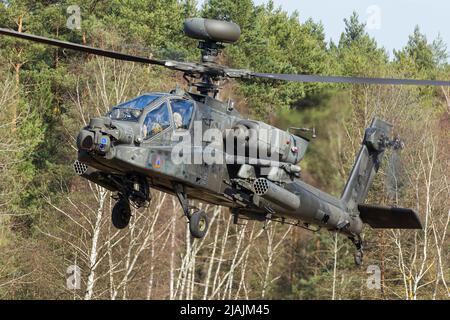 A U.S. Army AH-64 Apache attack helicopter takes off from Grafenwohr, Germany. Stock Photo