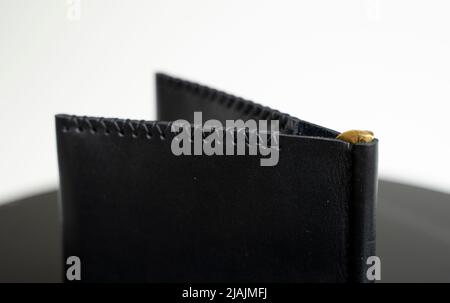 Black men's money clip handmade leather wallet. Empty money clip wallet with a two pockets for cards. Stock Photo