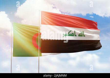 Sunny blue sky and flags of iraq and algeria Stock Photo