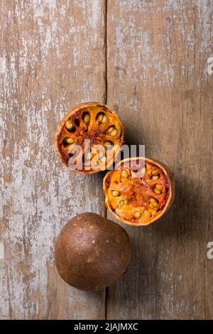 ripe bael fruits, also known as bengal quince, golden apple or stone apple, sweet aromatic, medicinal benefits fruit on table top taken from above Stock Photo