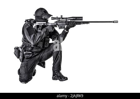 SWAT team sniper sitting and aiming with sniper rifle equipped telescopic optical sight. Stock Photo