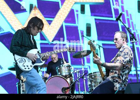 Musicians Rivers Cuomo and Scott Shriner are shown performing on stage during a live concert appearance with Weezer at the Boston Calling music festival in Allston, Massachusetts on May 29, 2022. Stock Photo