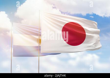 Japan flag and Argentina flag waving together on blue sky, two country ...