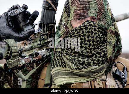 Close-up of Army sniper with face hidden behind shemagh. Stock Photo