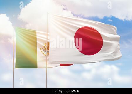 Sunny blue sky and flags of japan and mexico Stock Photo