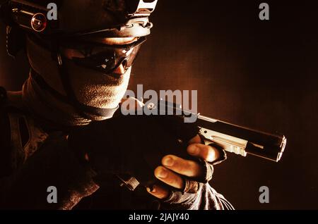 Police SWAT team fighter aiming pistol while sneaking in the darkness. Stock Photo