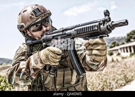 Close-up of a commando fighter shooting a submachine gun. Stock Photo