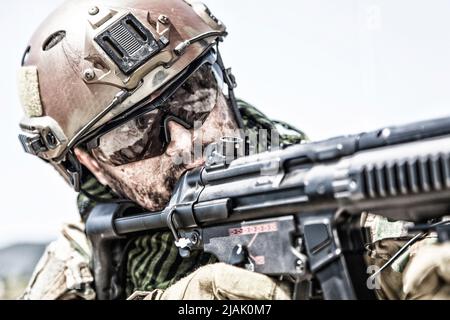 Close-up of a commando fighter shooting a submachine gun. Stock Photo