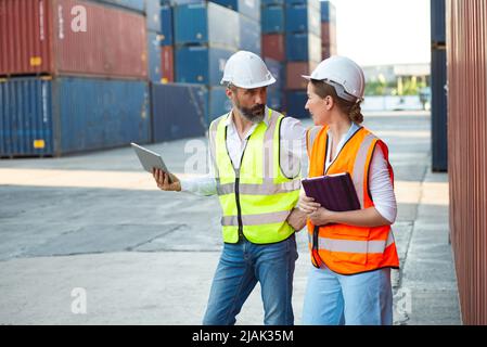 Male and female manager discuss and checking about their job for shipment to customer. Distribution storage commerce port cargo. Stock Photo