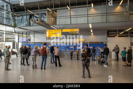 People at Eindhoven airport waiting for arriving passengers to arrive at the arrival hall Stock Photo