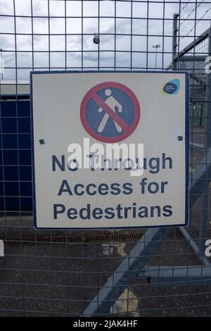 No Through access for pedestrians sign hanging on a metal fence at London Southend airport (SEN) Stock Photo