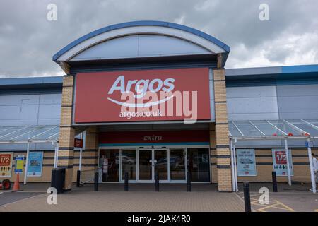 Argos store entrance. Big red and white sign over glass doors. Argos is a British catalogue and shop retailer in the UK Stock Photo
