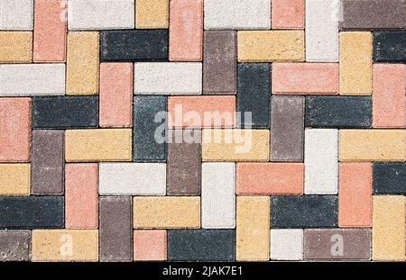Sidewalk is lined with multi-colored road tiles. View from above. Stock Photo