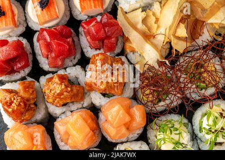 Sushi set of various products on a black stone plate Stock Photo