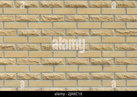 Solid yellow and beige brick wall. Brick background. Stock Photo