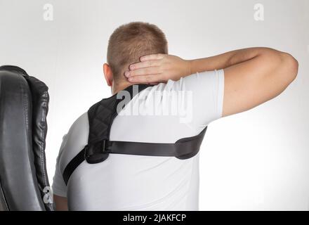 A Male is Wearing an Orthopedic Posture Corrector. Treatment for