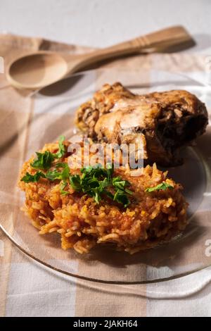 https://l450v.alamy.com/450v/2jakh64/bowl-of-east-african-jollof-rice-garnished-with-pieces-of-roasted-chicken-vertical-photo-2jakh64.jpg