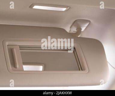 Modern car sun visor with mirror, close-up Stock Photo