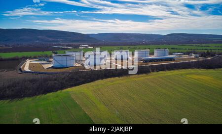 Drone photo of industrial buildings grain silos to plowed unsown fields ...