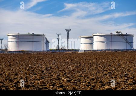 White grain silos to plowed unsown fields Stock Photo - Alamy