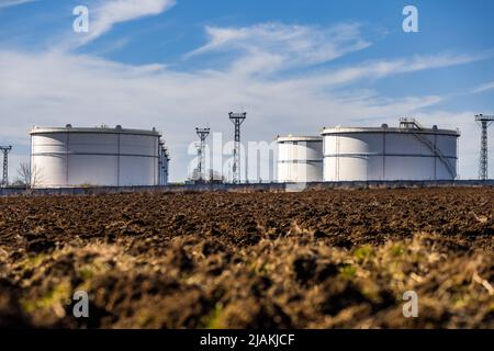 White grain silos to plowed unsown fields Stock Photo - Alamy