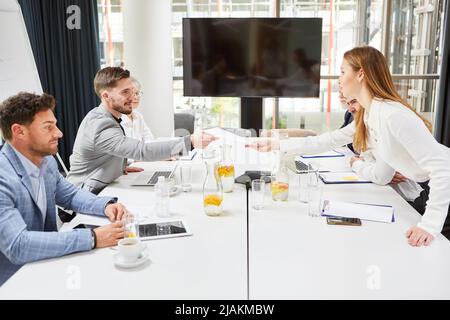 Business people work together in a meeting and exchange documents Stock Photo