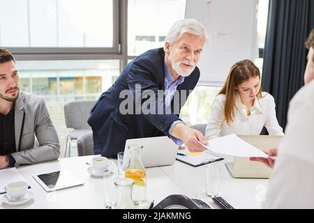 Employer or manager presents trainee or employee with an employment contract Stock Photo