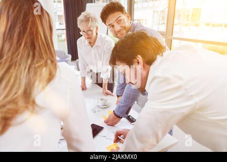 Modern business team collaborating on project planning in conference room Stock Photo