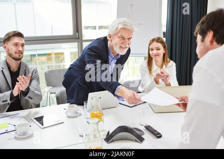 The HR manager gives employees or applicants a job reference or employment contract Stock Photo