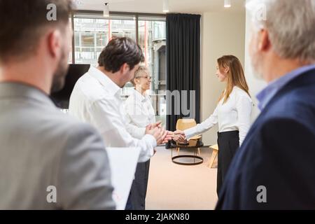 Senior business woman shakehands with trainee as concept for welcome or promotion Stock Photo