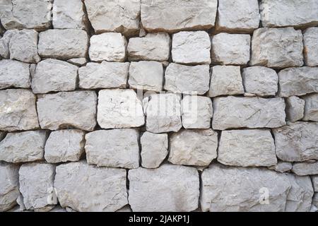 fence wall made of large rock stones Stock Photo