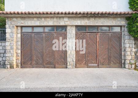Old garage with shabby wooden gates for two cars Stock Photo