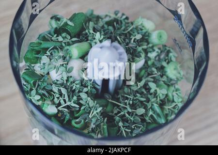 Spring onion and thyme in a food processor Stock Photo