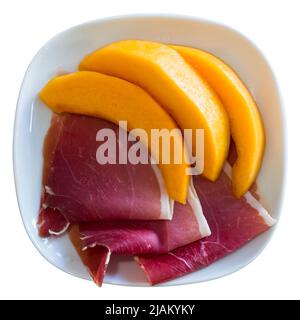 Fresh melon with slices of jamon Stock Photo