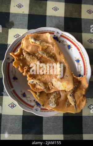 Traditional fish chips called 'kerupuk sala ikan' at a roadside restaurant in Solok, West Sumatra, Indonesia. Stock Photo