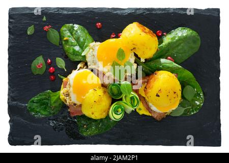 Plate with mini burgers from scrambled quail eggs with potatoes and greens Stock Photo