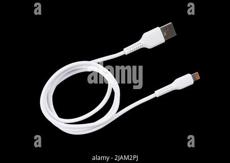 USB cable isolated on black background. Mobile phone charging cable. White USB cable for charging a smartphone isolated Stock Photo