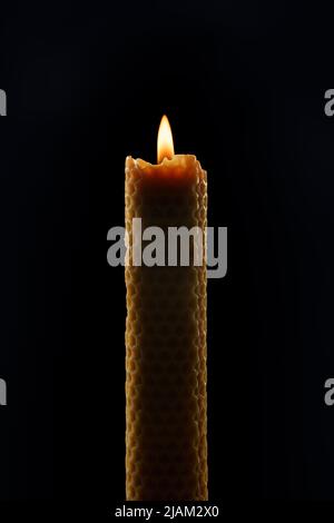 Burning wax candle isolated on black background, clipping path included Stock Photo