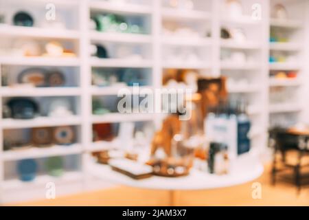 View of assortment of decor for interior shop in store of shopping center. View of shelving with dishes, bowls, plates. View of home accessories for Stock Photo