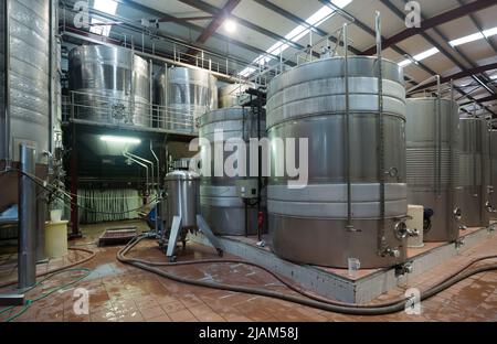 Stainless cisterns with fermenting wine in fabric Stock Photo