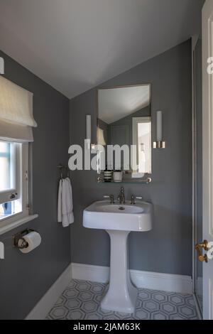 Small grey themed shower room in Victorian house Stock Photo