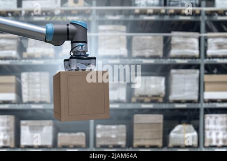 Robot arm moves boxes in an automatic warehouse. Concept  Stock Photo