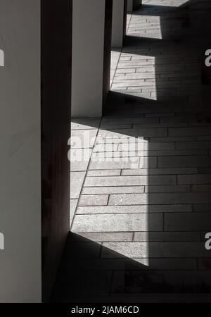 Repetition of pillars and play of contrasts between shadows and light on a sunny day Stock Photo