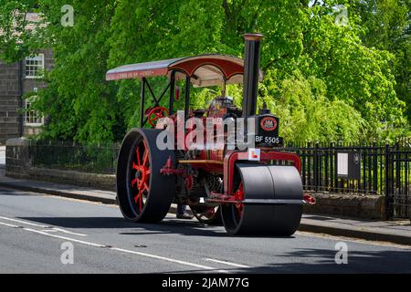 Red black stationary heavy steam-powered vehicle parked at roadside (L-plate & reg number on front) - Burley-in-Wharfedale, West Yorkshire England UK. Stock Photo