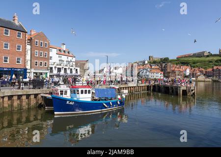 General view of fishing boats in Whitby Harbour on the River Esk in Whitby, North Yorkshire, England. Stock Photo