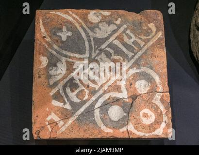 Ceramic tile from the Whitby Abbey church floor (c.1300) on display in Cholmley House, Whitby Abbey Museum, Whitby, North Yorkshire, England. Stock Photo