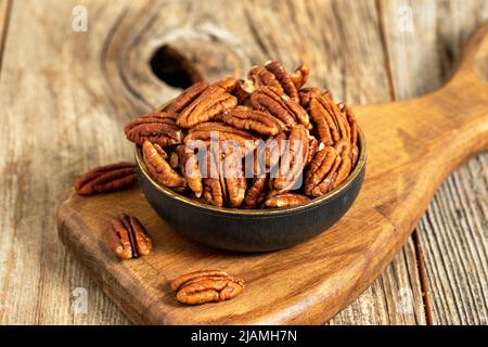 Pecan walnuts on wooden background. close up Stock Photo